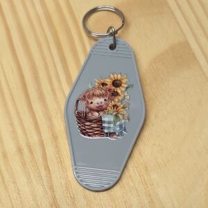 Gray Keychain with Highland Cow In Basket With Sunflowers.